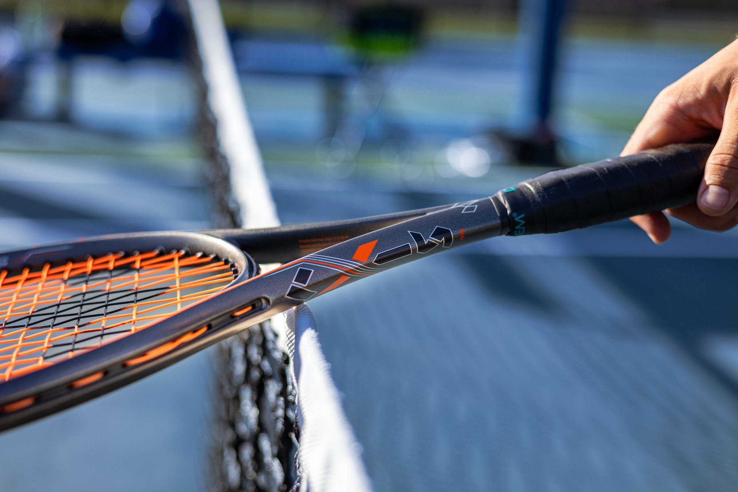 A Diadem Axis racket resting on the net